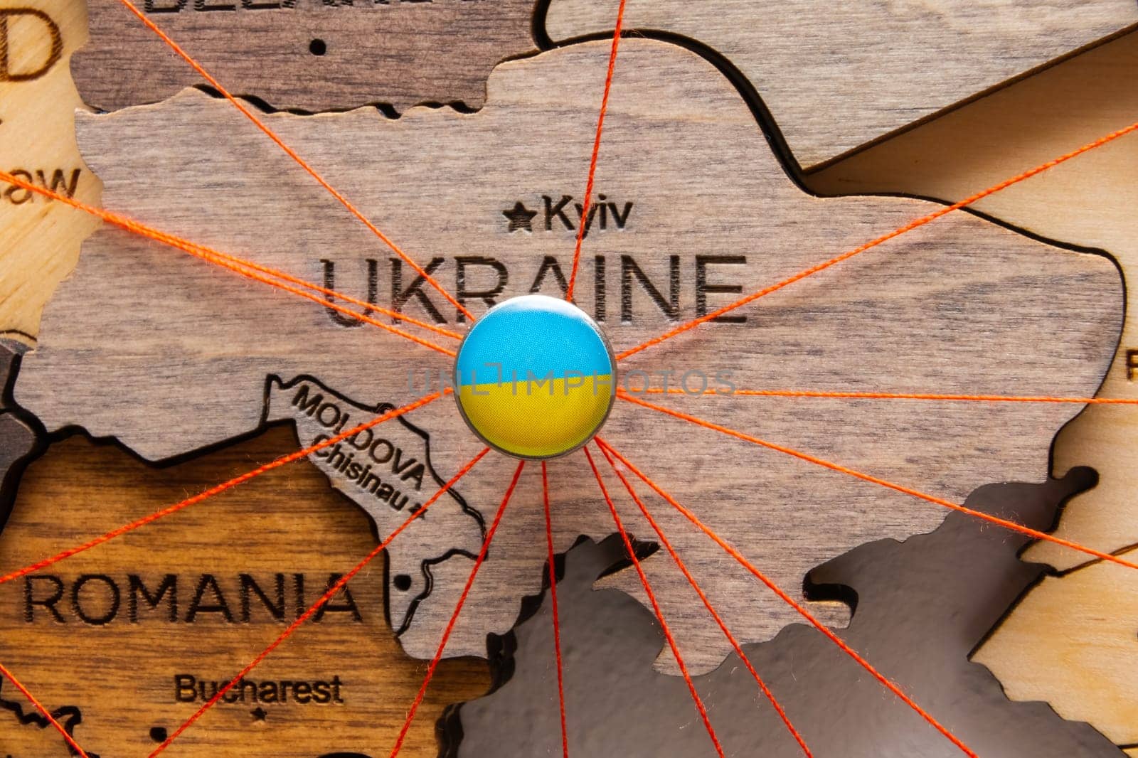 Ukraine flag pins and red thread for traveling and planning trips. Planning of logistics routes or spheres of influence in geopolitics