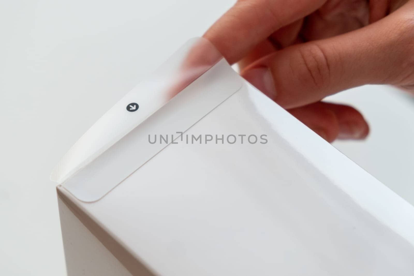 Close up unboxing of a white box by female hands. Getting a gift concept.