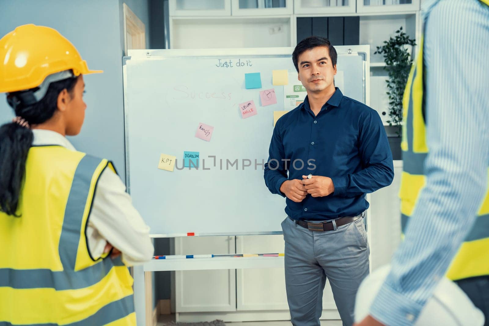 A team of investor and competent engineers brainstorming on the whiteboard to find new ideas and making plans. The idea of a team gather ideas together.