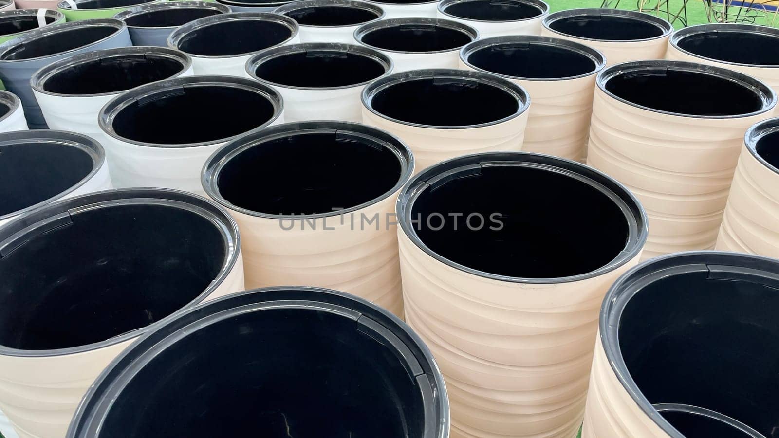 Close-up of empty flower pots in a store or greenhouse. Colorful pots for plants. Gardening and landscape design concept.