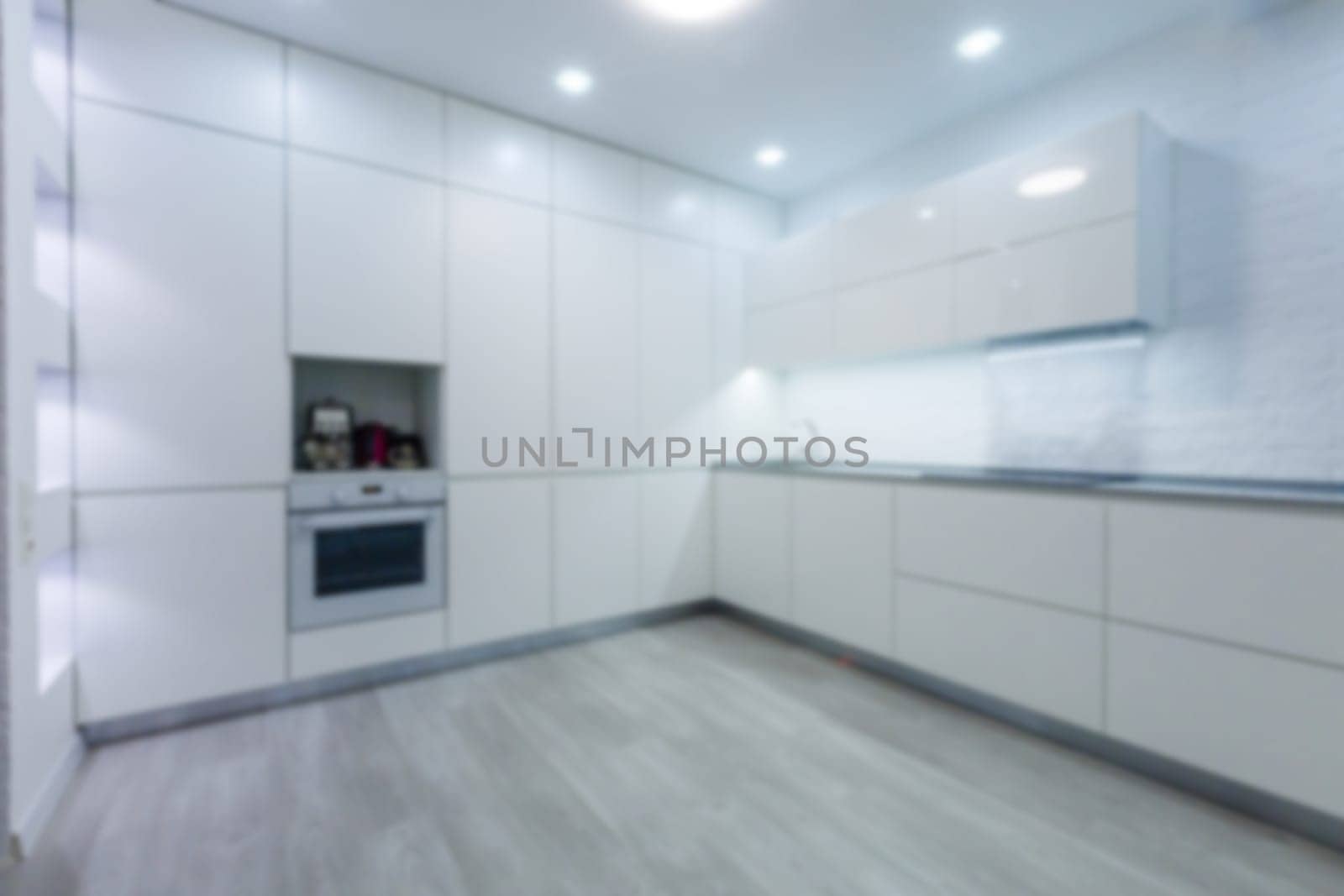 Blurred view of modern kitchen interior with white furniture. High quality photo