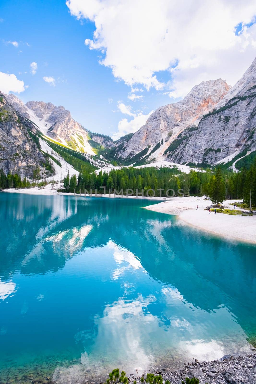 A vertical shoot of a cinematographic view of the beautiful landscape of Lake Braies with turquoise water and high Dolomites mountains