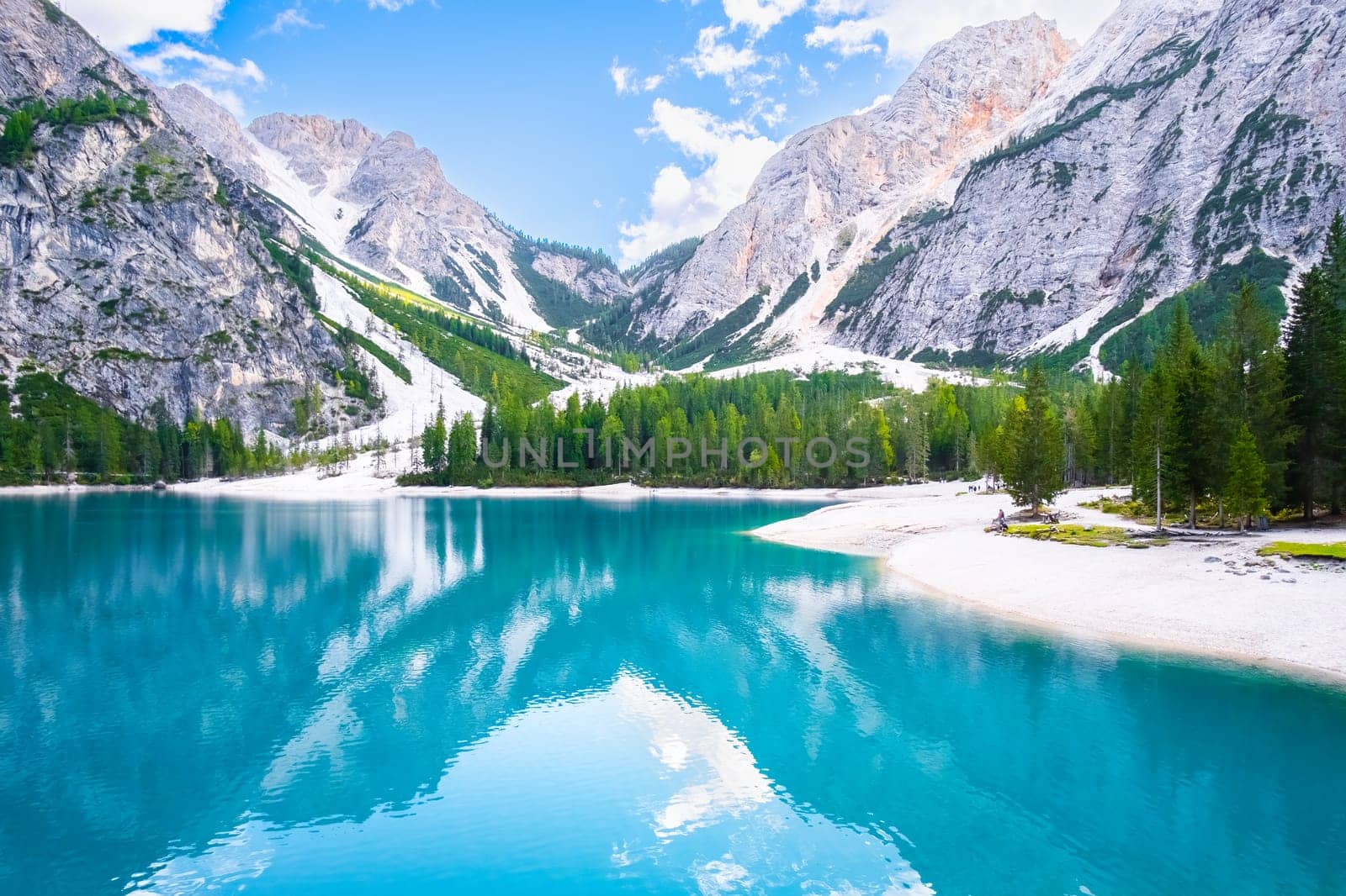 Cinematographic view of the beautiful landscape of Lake Braies with turquoise water and high Dolomites mountains.