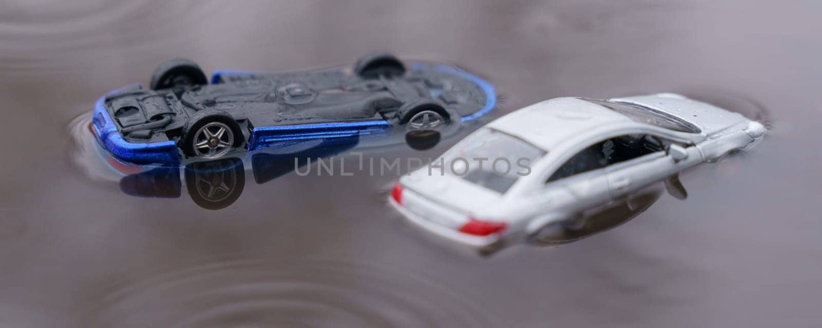 Natural disasters. Two cars were flooded, one overturned as a result of the flood. One of them is out of focus.