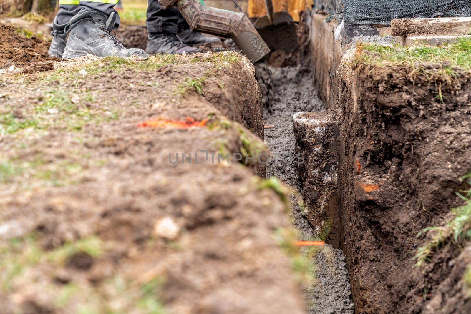 cementing the foundation in the ground when building a house.