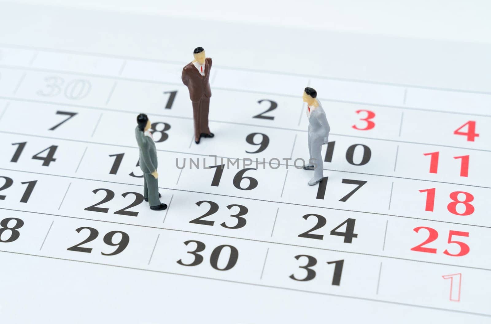 Business and finance concept. There are miniature figures of businessmen on the calendar - business planning