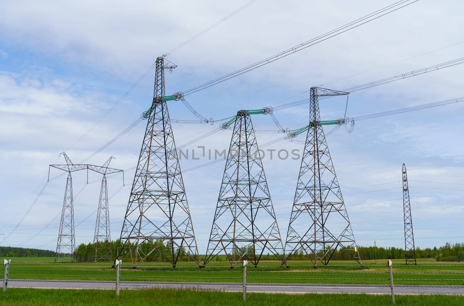 Industrial concept. Towers and high-voltage power lines in the field.