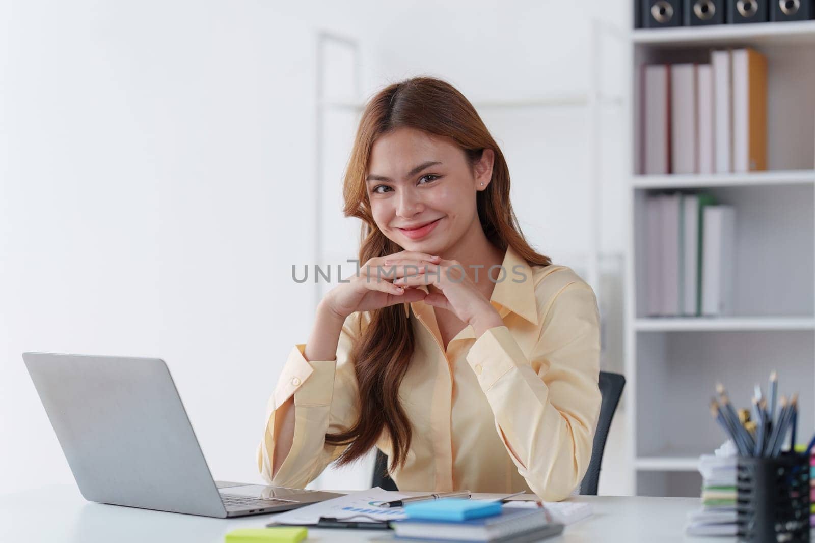 Asian Business person makes analysis and research financial report at office, analyzes profits. Accountant checks status of financial.