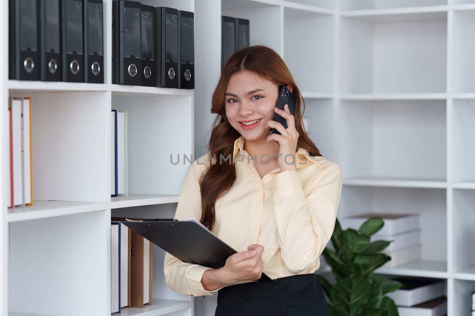 Professional Financial advisor, corporate Accountant woman talking with client by phone. analyzing benefits, enjoying financial.