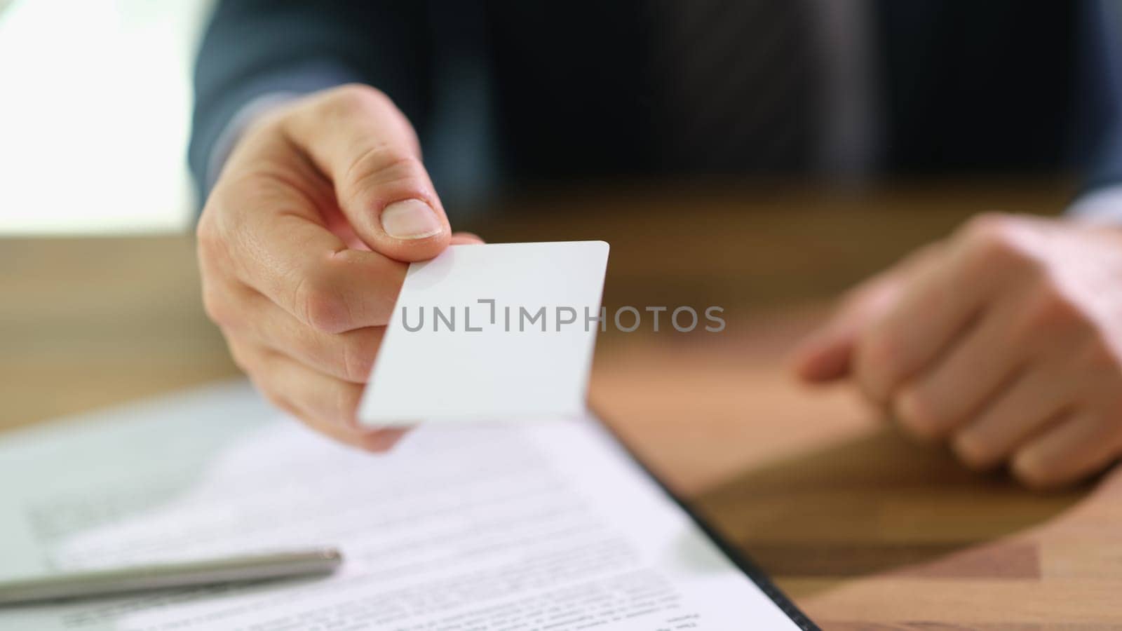 Businessman banker giving credit bank card to client closeup. Business investment concept