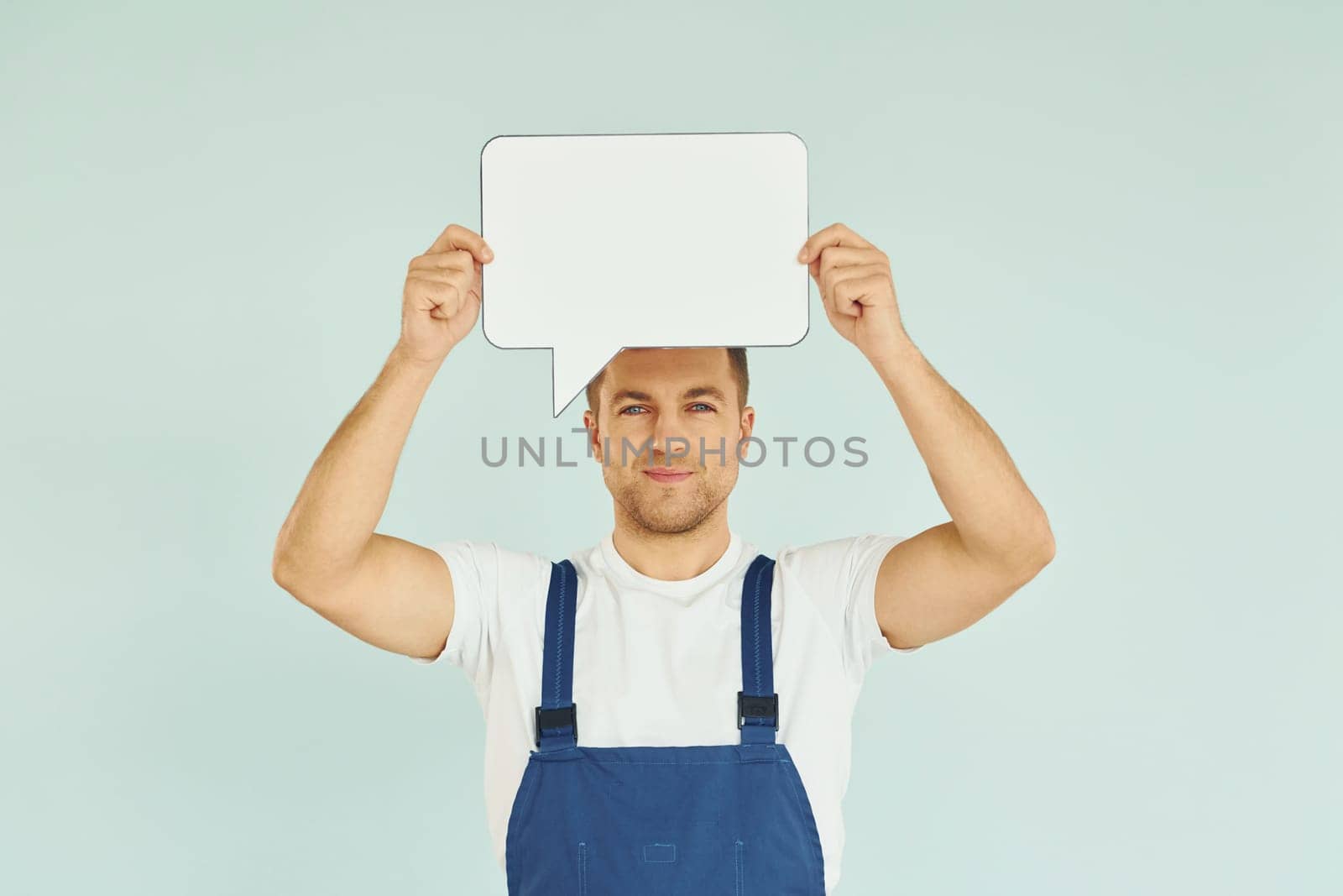 Worker saying something. Man standing in the studio with empty signs for the text.