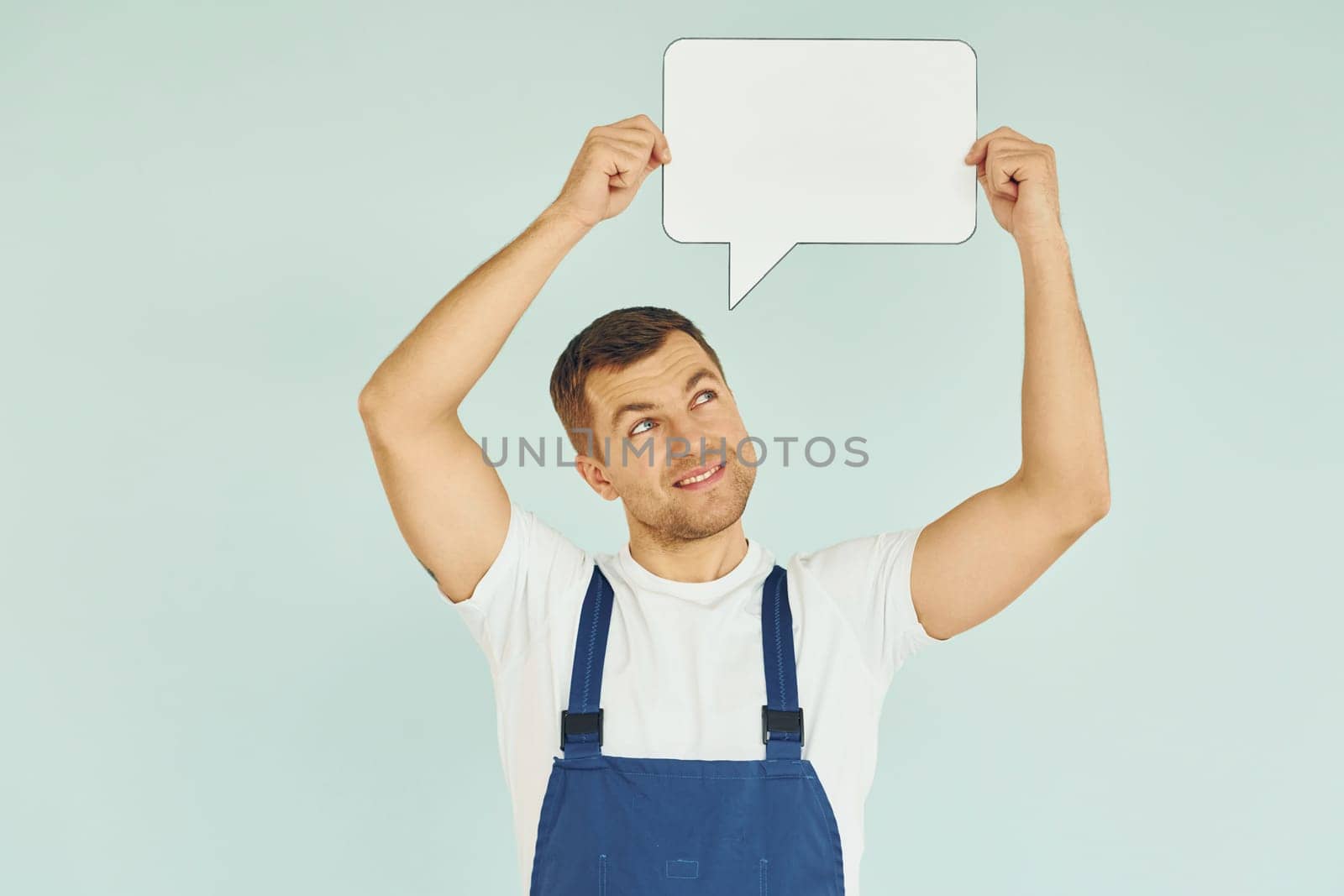 Worker saying something. Man standing in the studio with empty signs for the text.