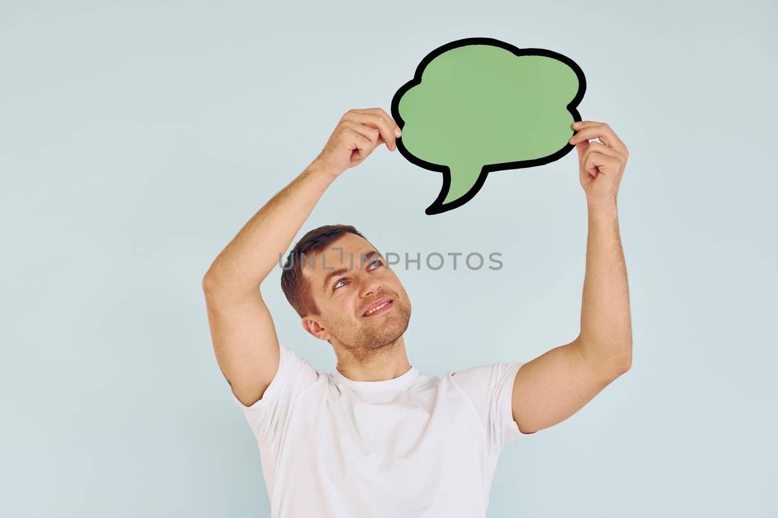 Cloud looking signs. Man standing in the studio.