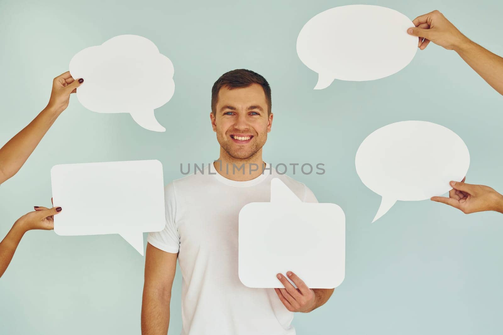 Man standing in the studio with empty signs for the text.