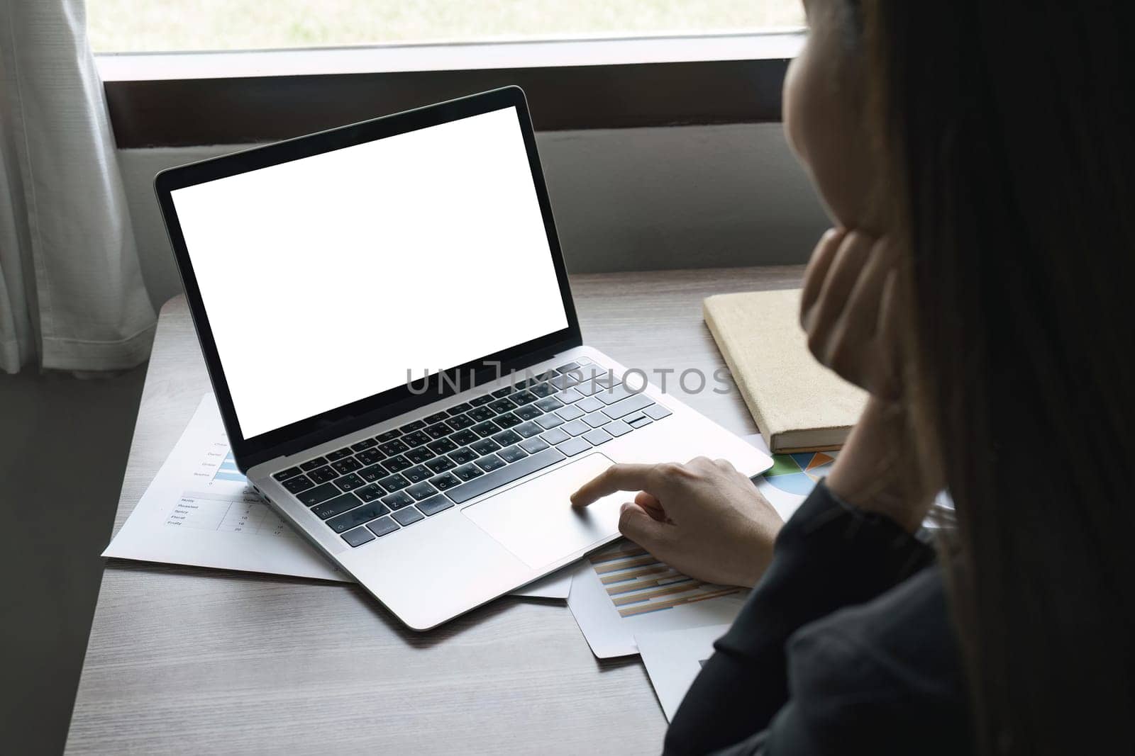 mockup image blank screen computer with blank white background for advertising text, hand woman using laptop contact business search information on desk at home office. marketing and creative design by nateemee
