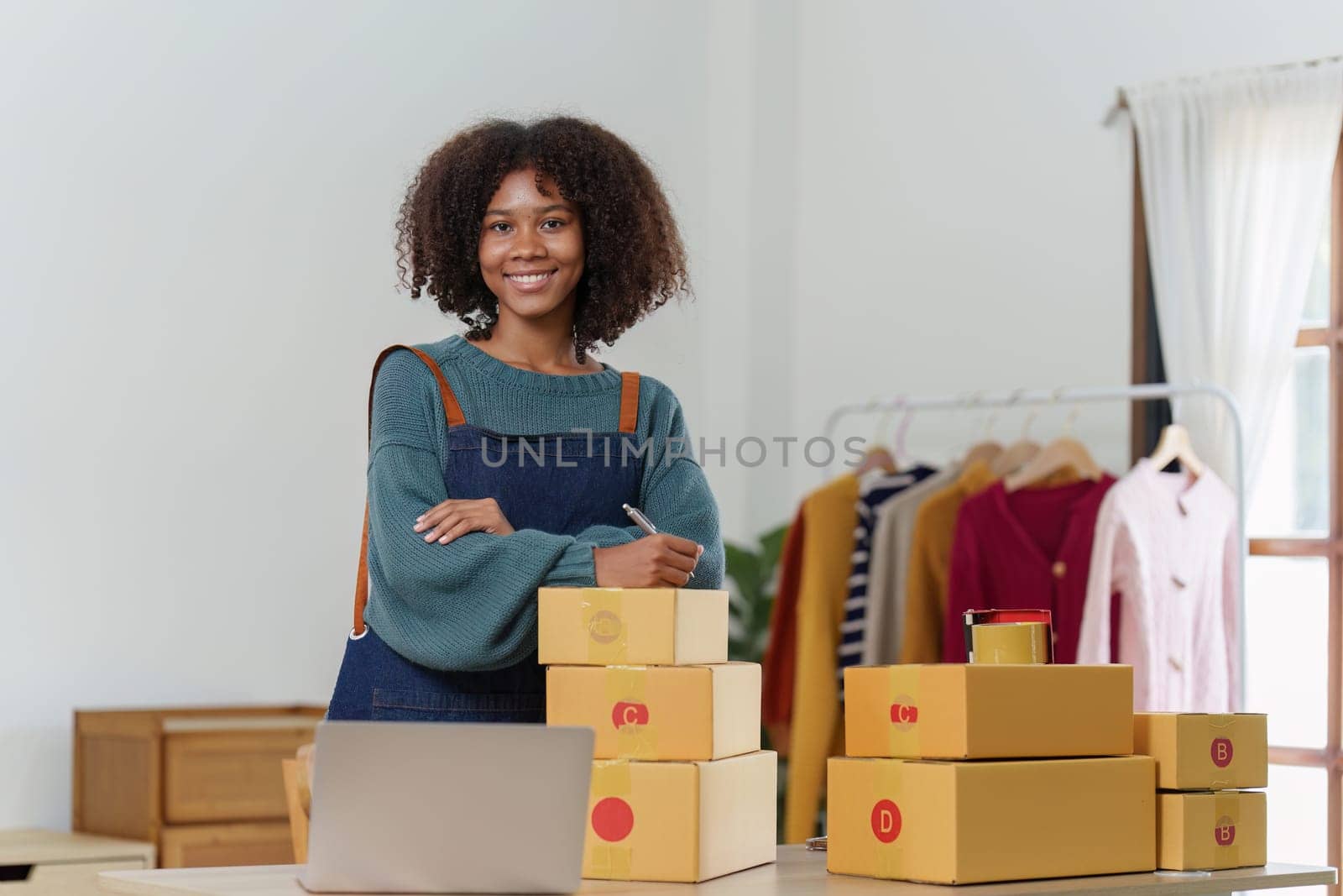 American African entrepreneur smile and checking online order. Successful SME entrepreneur concept by itchaznong