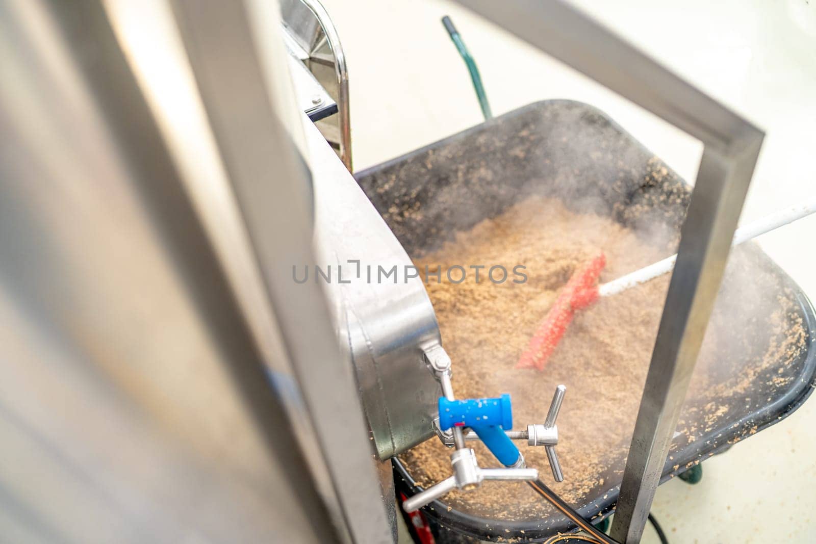 cleaning the boiler from residual malt after brewing beer in the brewery.