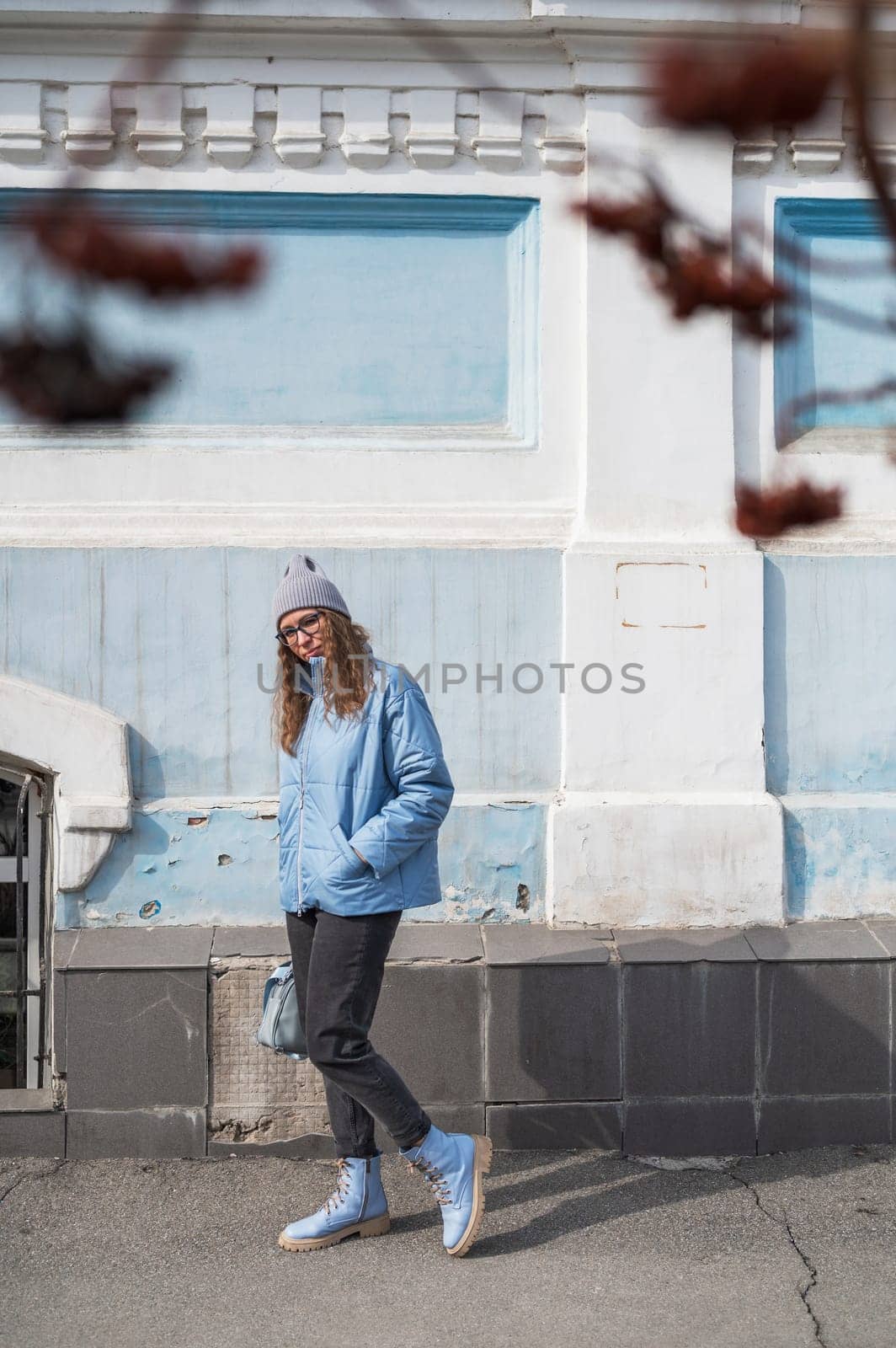 Portrait of a stylish woman in blue jacket. Spring outdoor portrait.