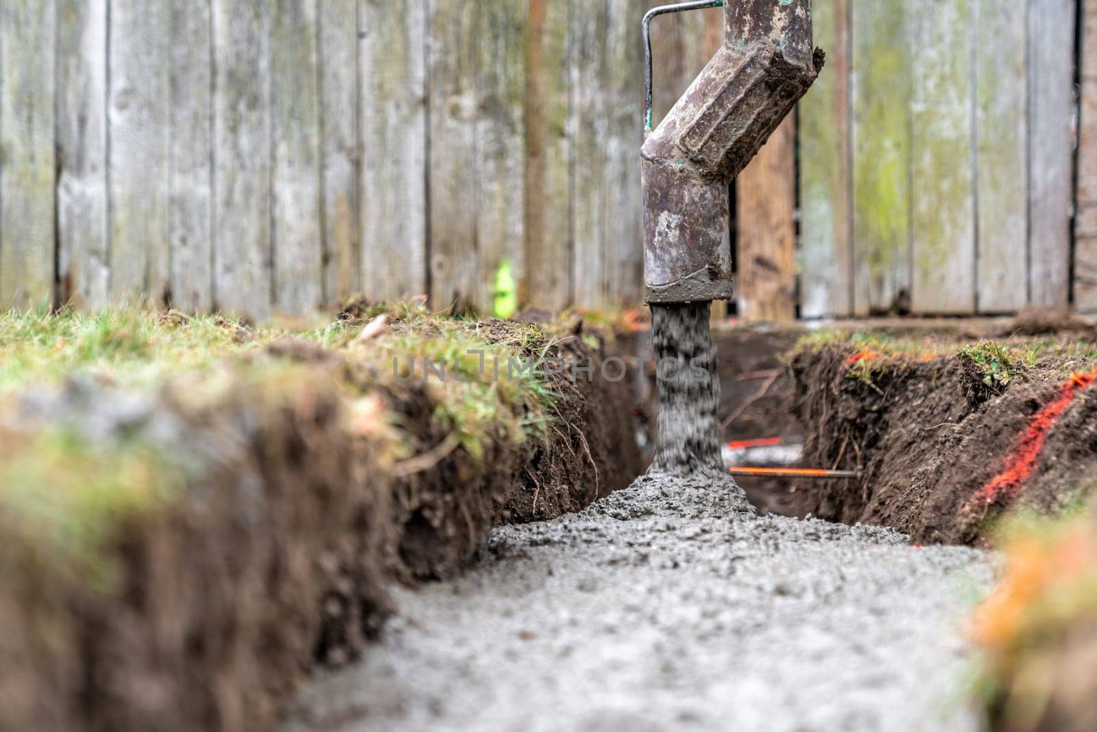 cementing the foundation in the ground when building a house.