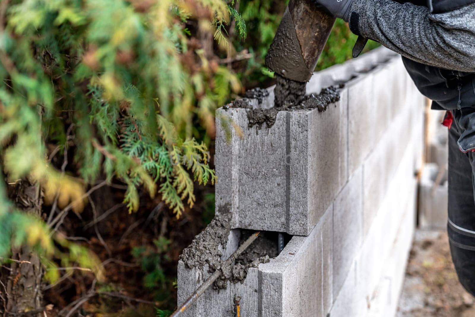 pour concrete from the mixer of the foundation of the building in the ground.