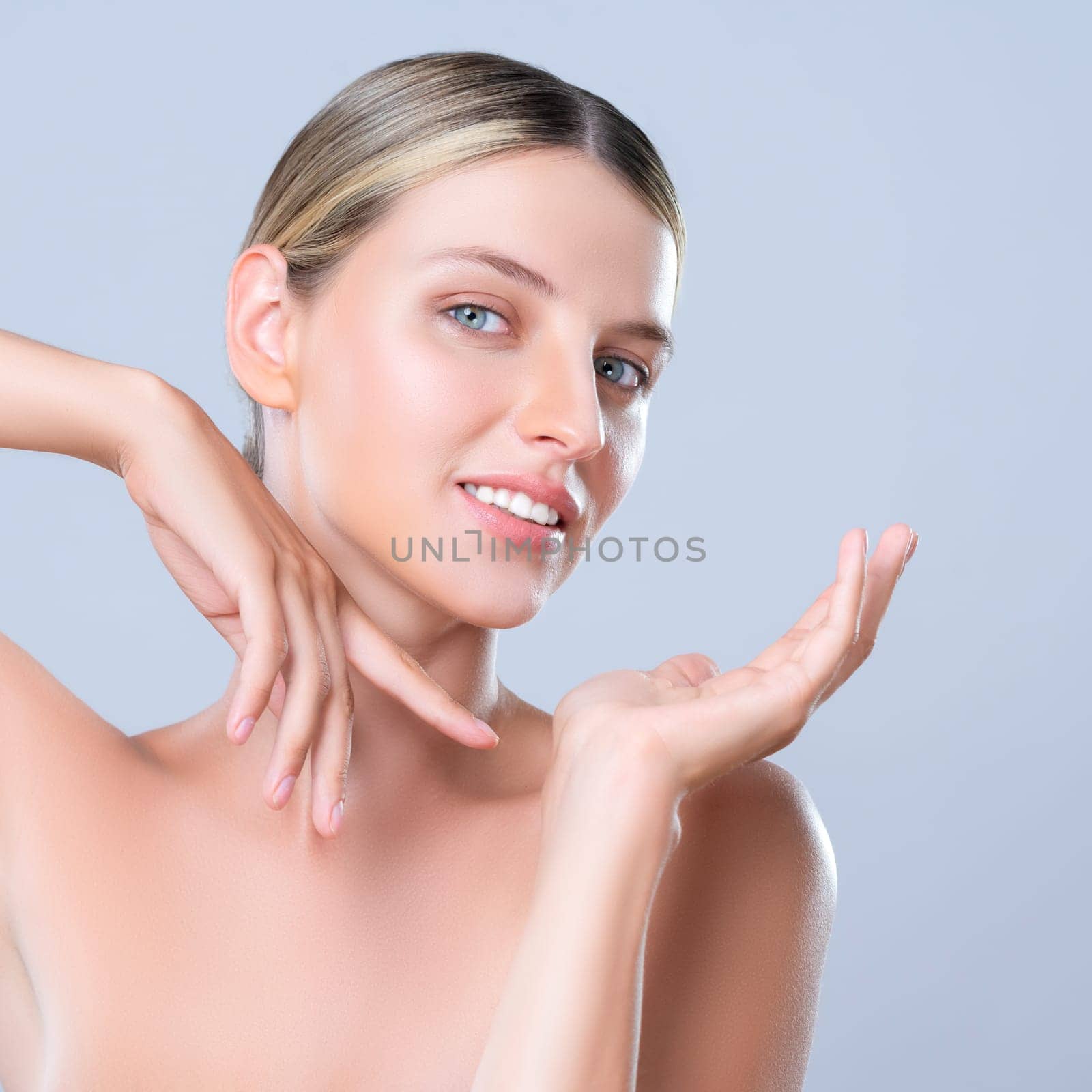 Alluring beautiful woman with perfect smooth and clean skin portrait in isolated background. Beauty hand gesture with expressive facial expression for skincare treatment product or spa.