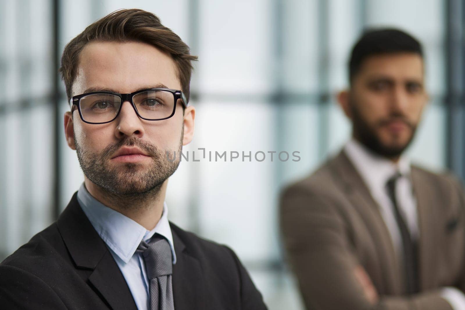 Portrait male worker looking at camera, positive employee posing for company business directory with co-workers