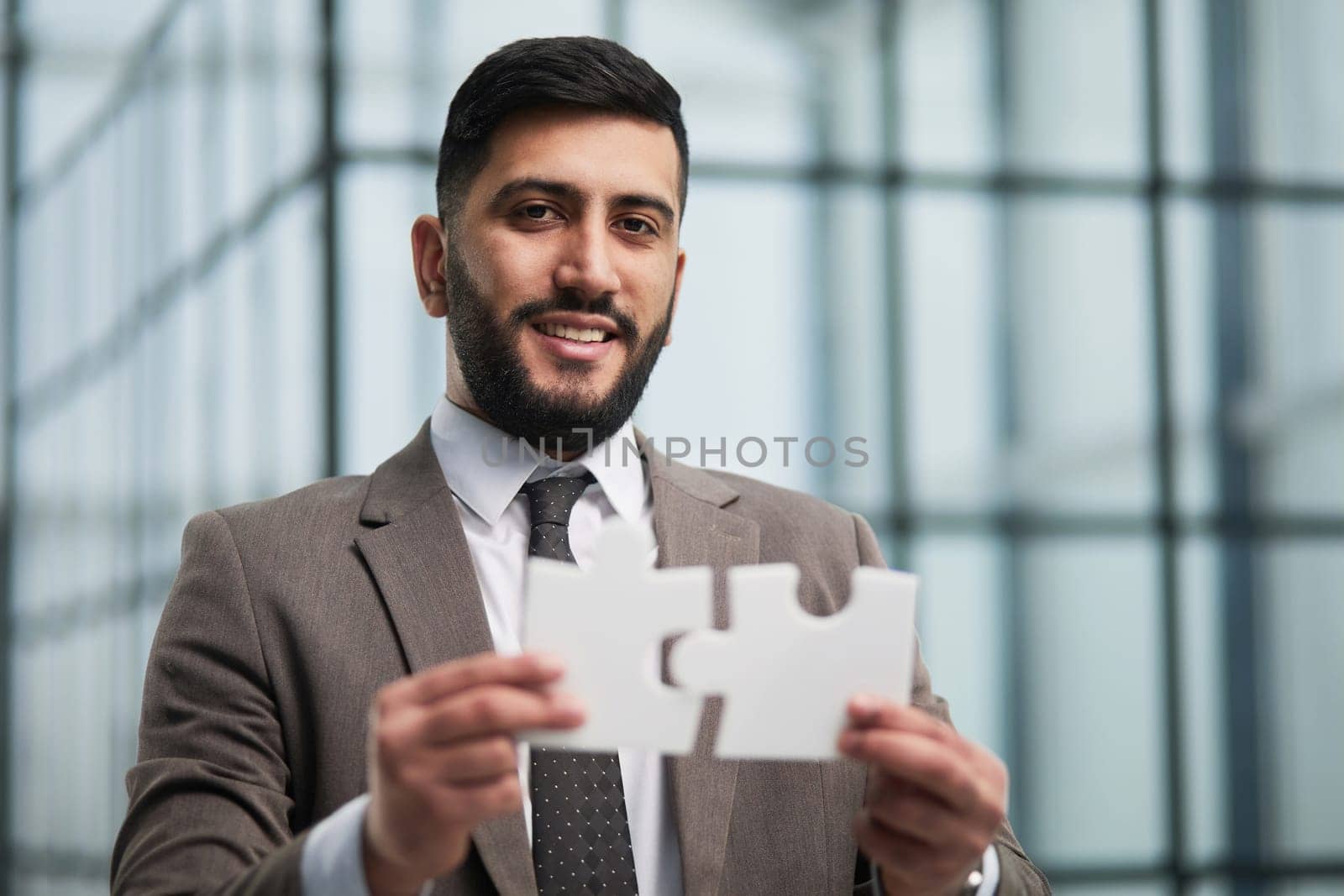 People holds in hand a jigsaw puzzle. Business solutions, success and strategy.