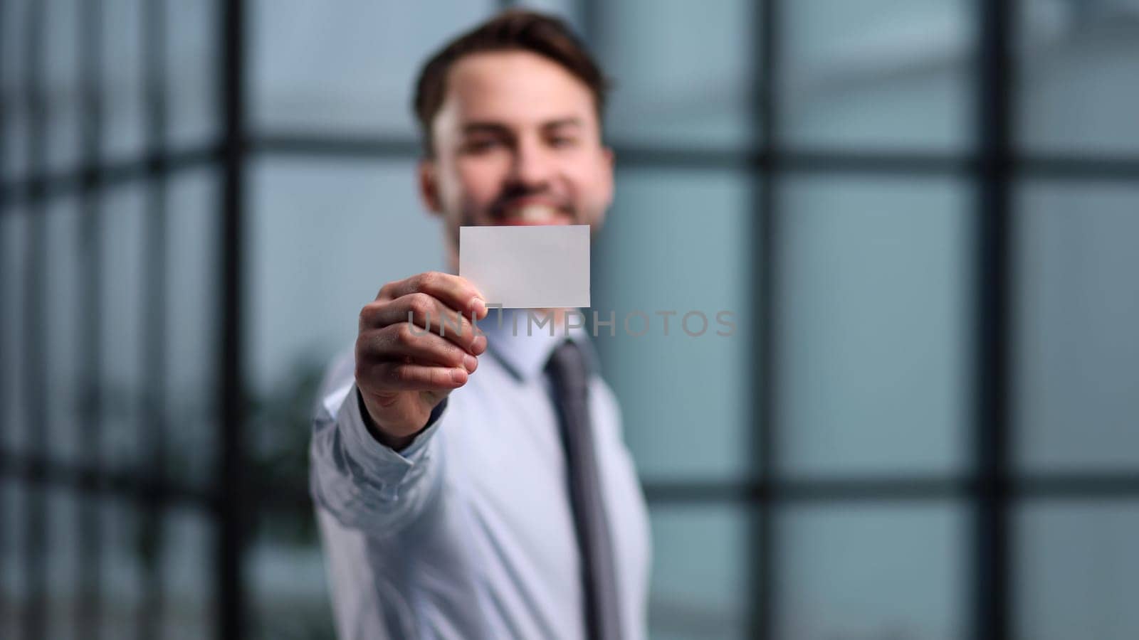Portrait of serious confident smart modern investor banker executive boss manager freelancer showing card