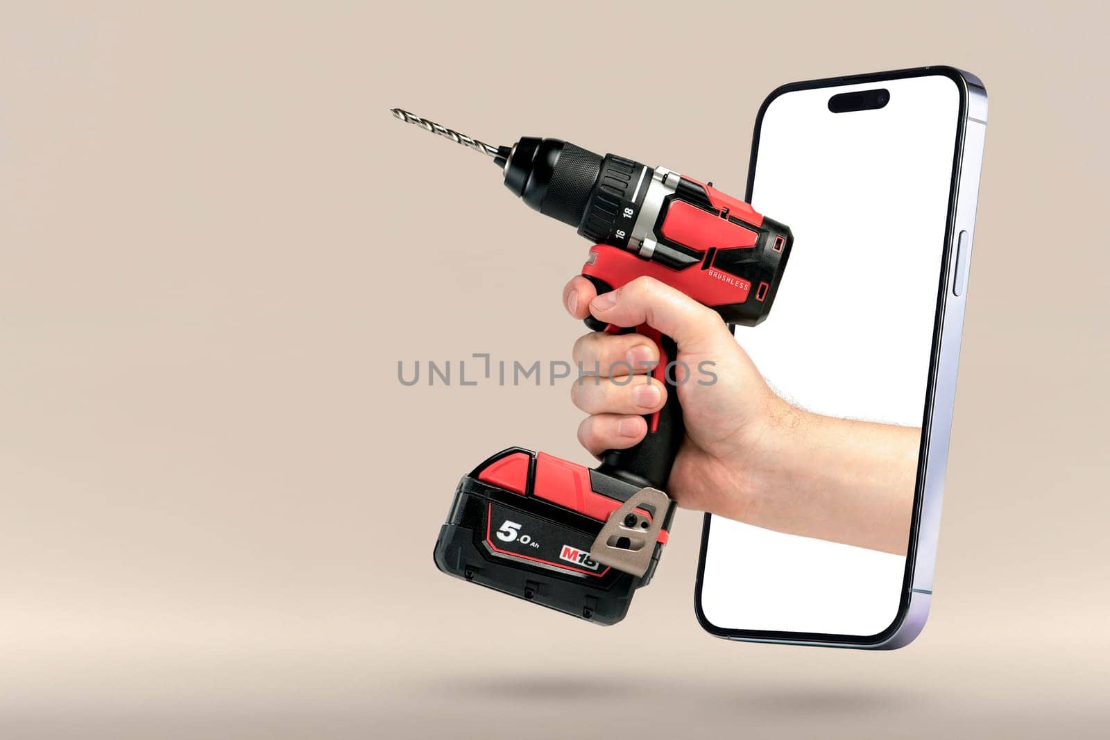 Buying power tools online. Online shopping banner. A screwdriver in hand protrudes from a mobile phone as a concept for buying tools on the Internet. by SERSOL