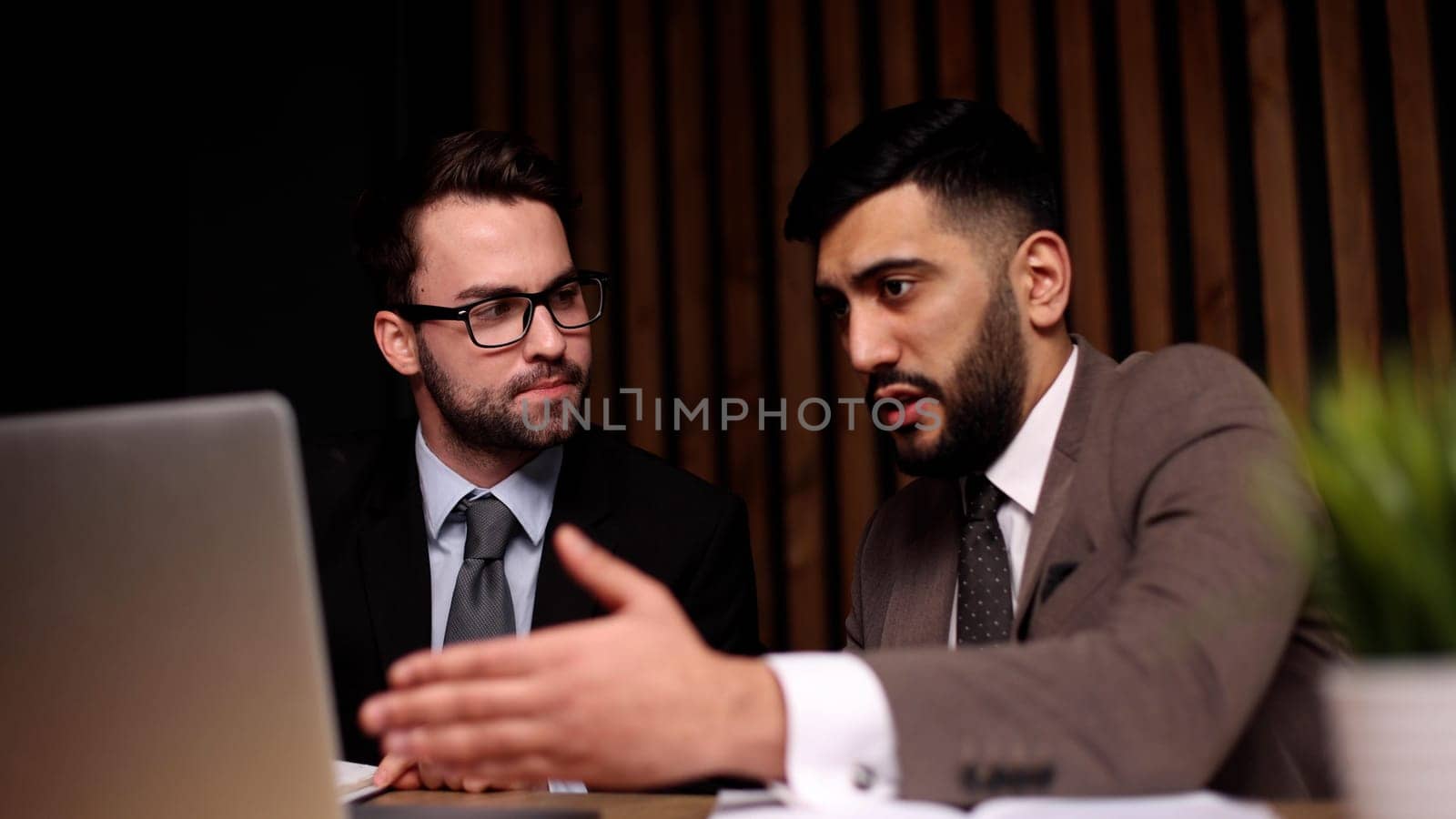 Business man having a discussion with his colleague in an office