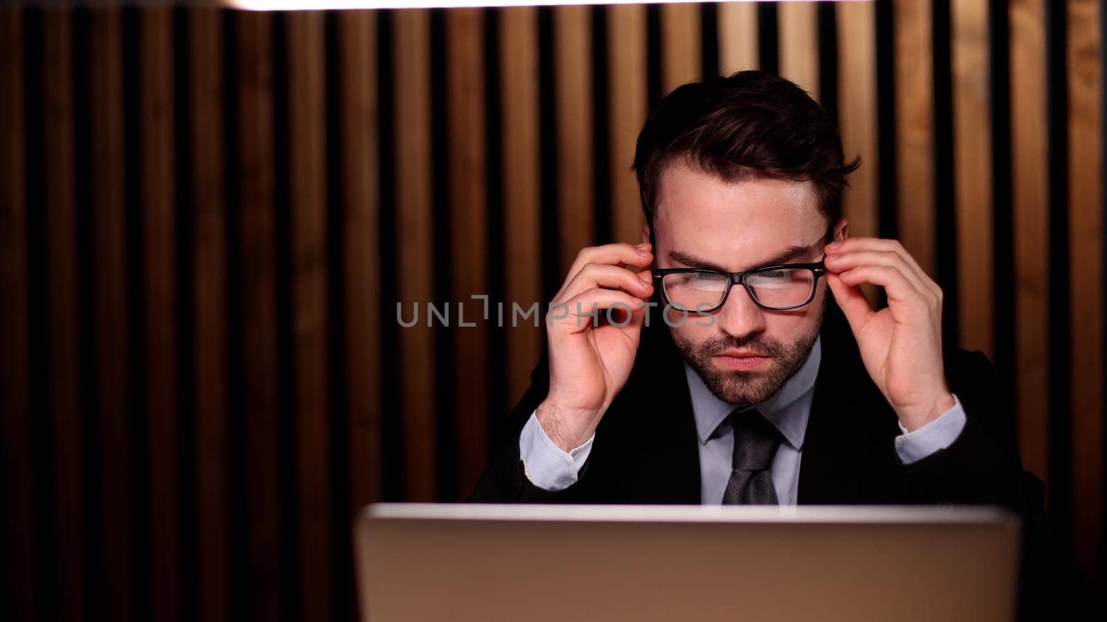 boss of the corporation looks into his laptop