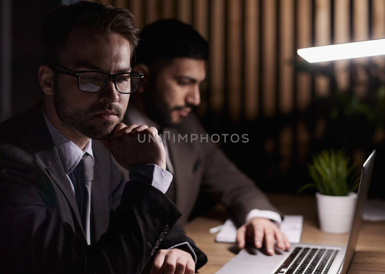 two business colleagues looking at the laptop screen