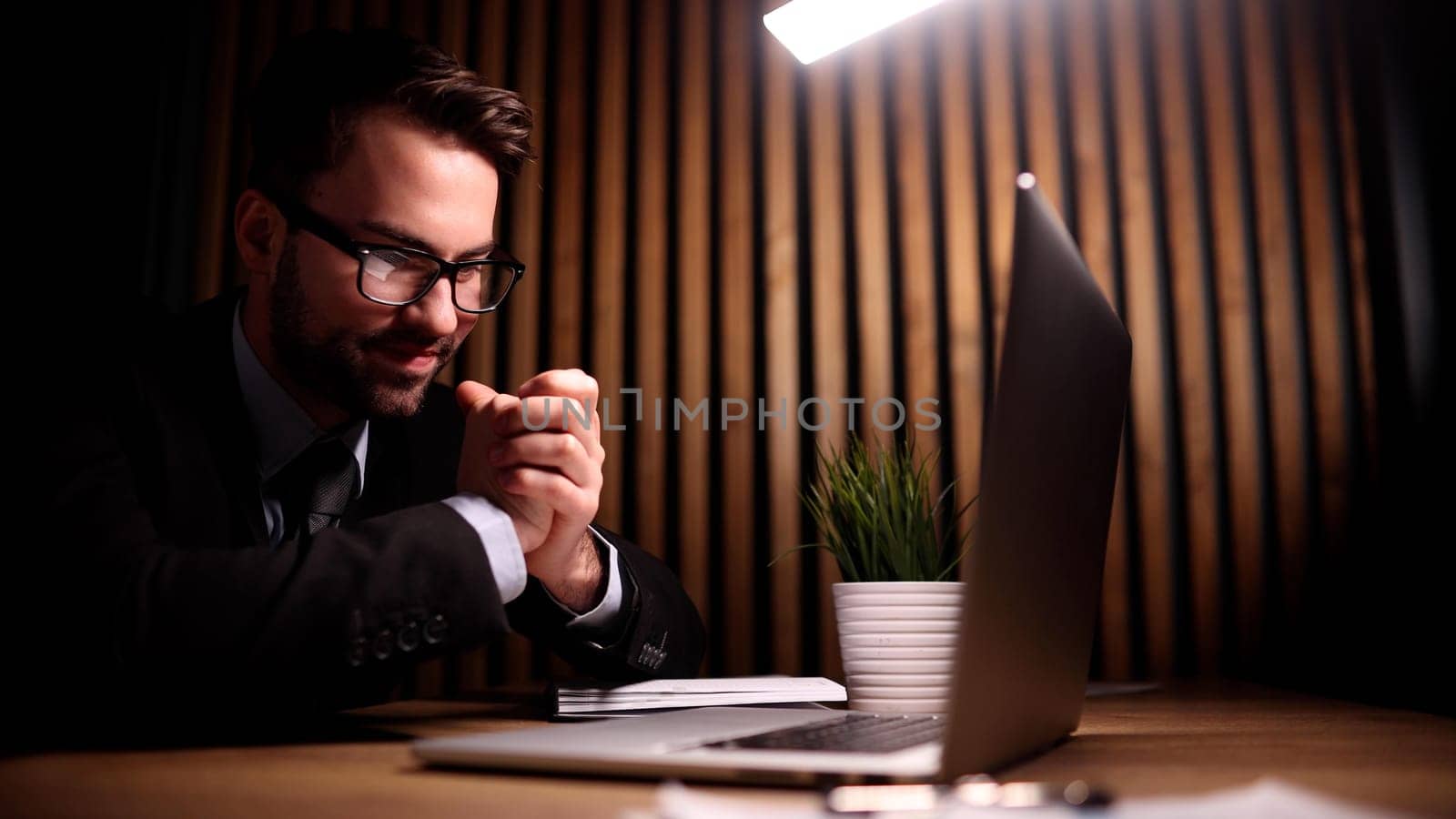 Business male is sitting in front of a laptop