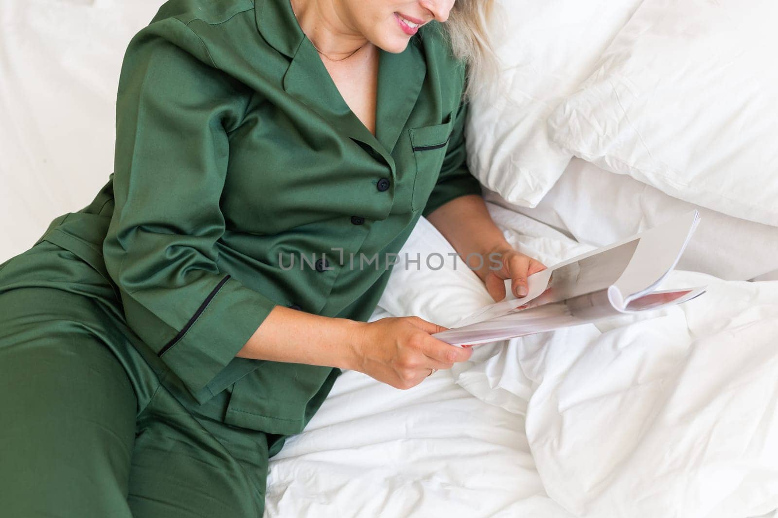 Close up woman wears pajama reads magazine in living room. Homewear, sleepwear, shopping and sale by Satura86