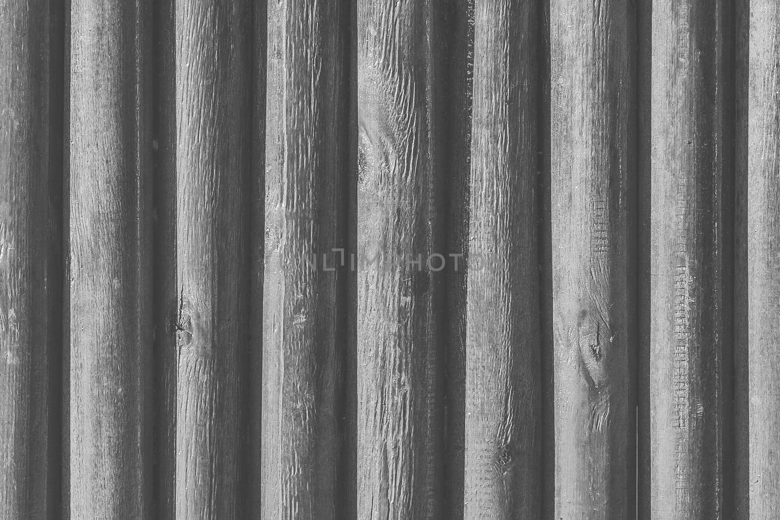 Large wood grey vertical logs fence plank texture board gray background.