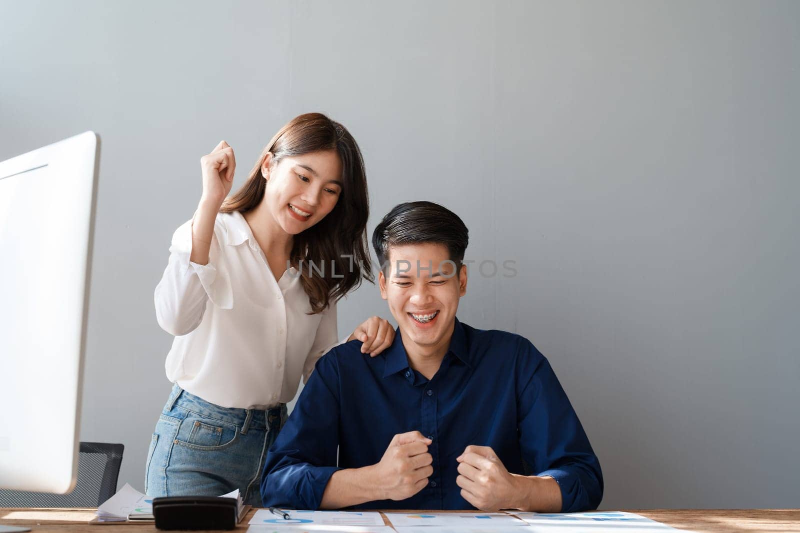 Family couple getting excited about success when they get email with excellent job offer looking at laptop computer with very excited face expressions.