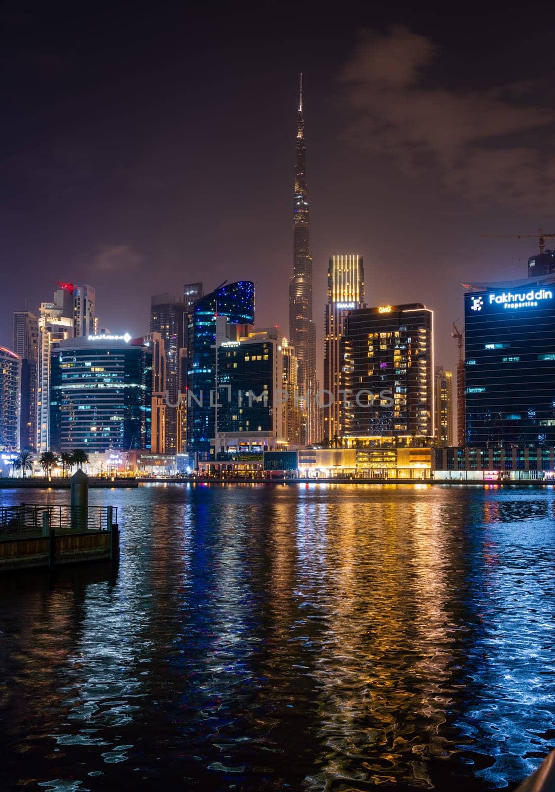 Dubai, UAE - April 1, 2023: Night view of skyline of downtown district from apartment in Business Bay