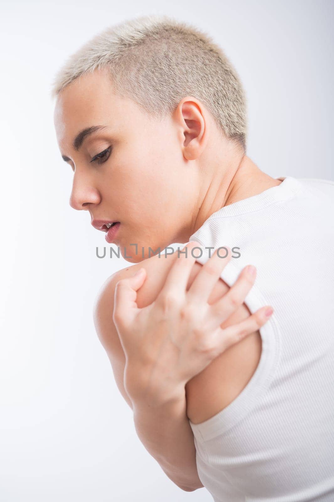 Pretty young woman with a short blond haircut on a white background. by mrwed54