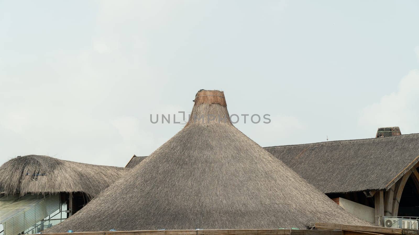 Thatched roof funnel against the sky by voktybre