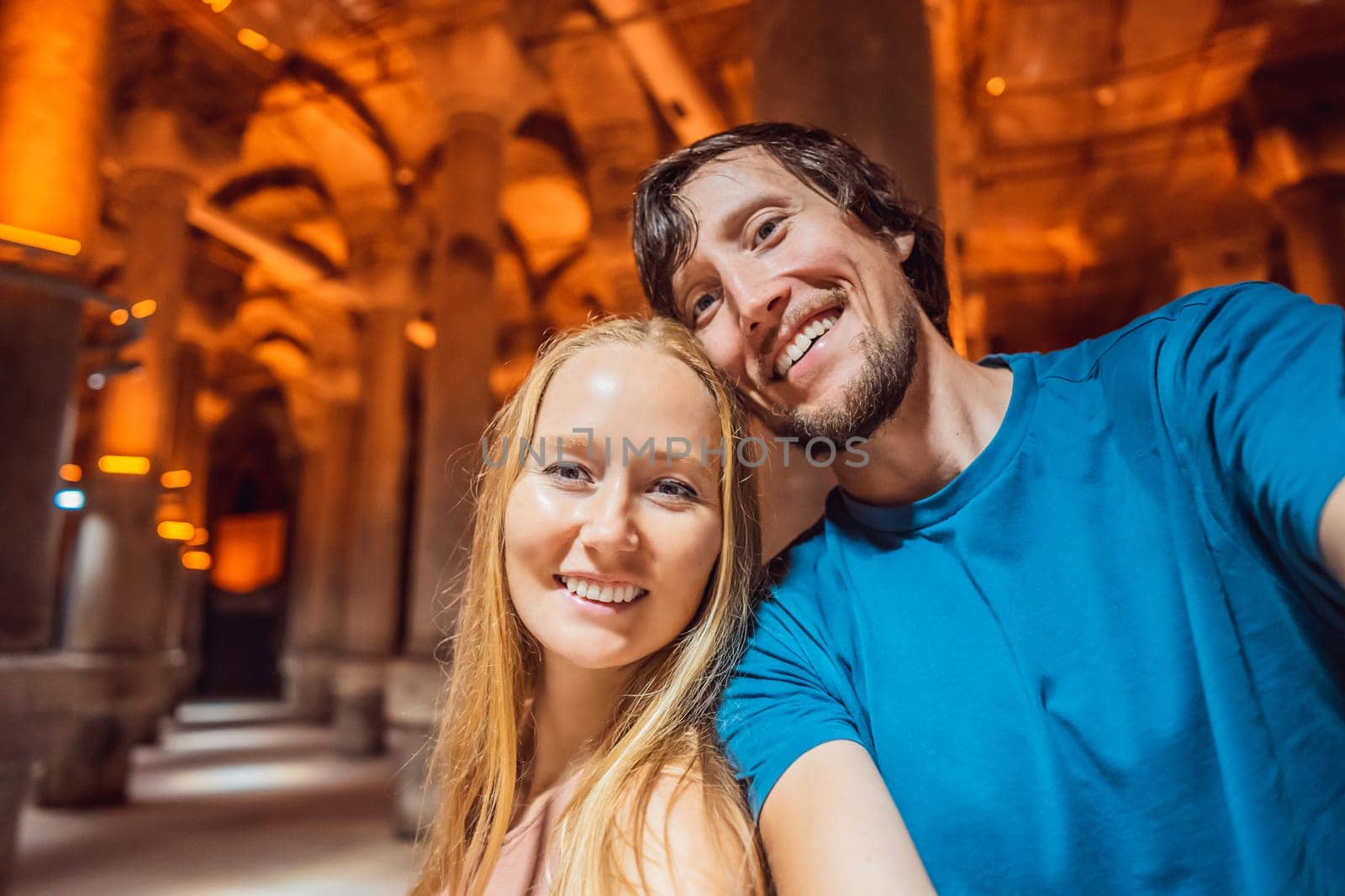 Happy couple enjoying Beautiful cistern in Istanbul. Cistern - underground water reservoir build in 6th century, Istanbul, Turkey, Turkiye.