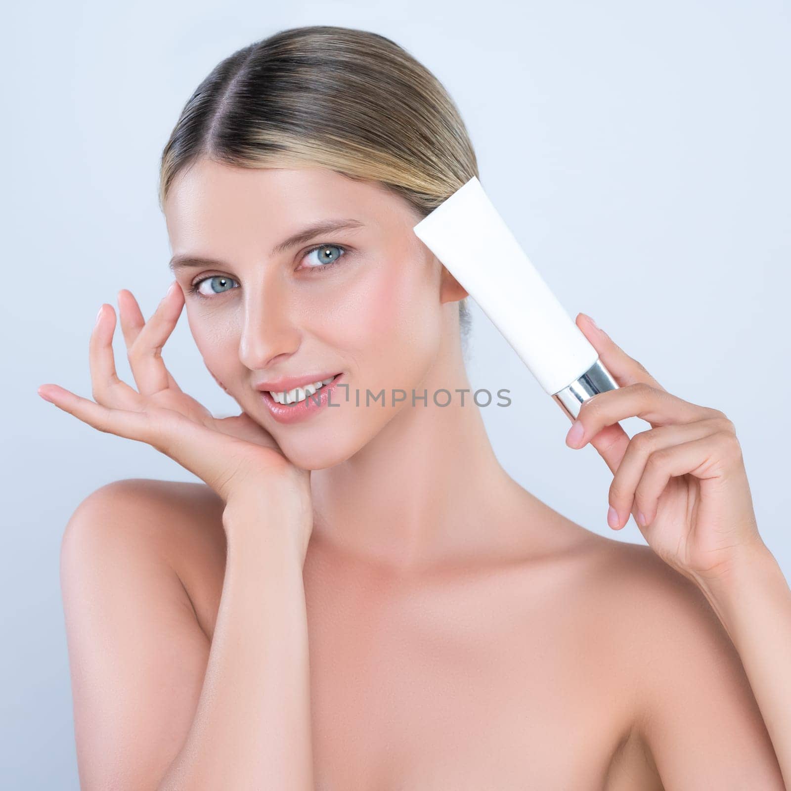 Alluring portrait of perfect skin woman holding mockup moisturizer tube. by biancoblue