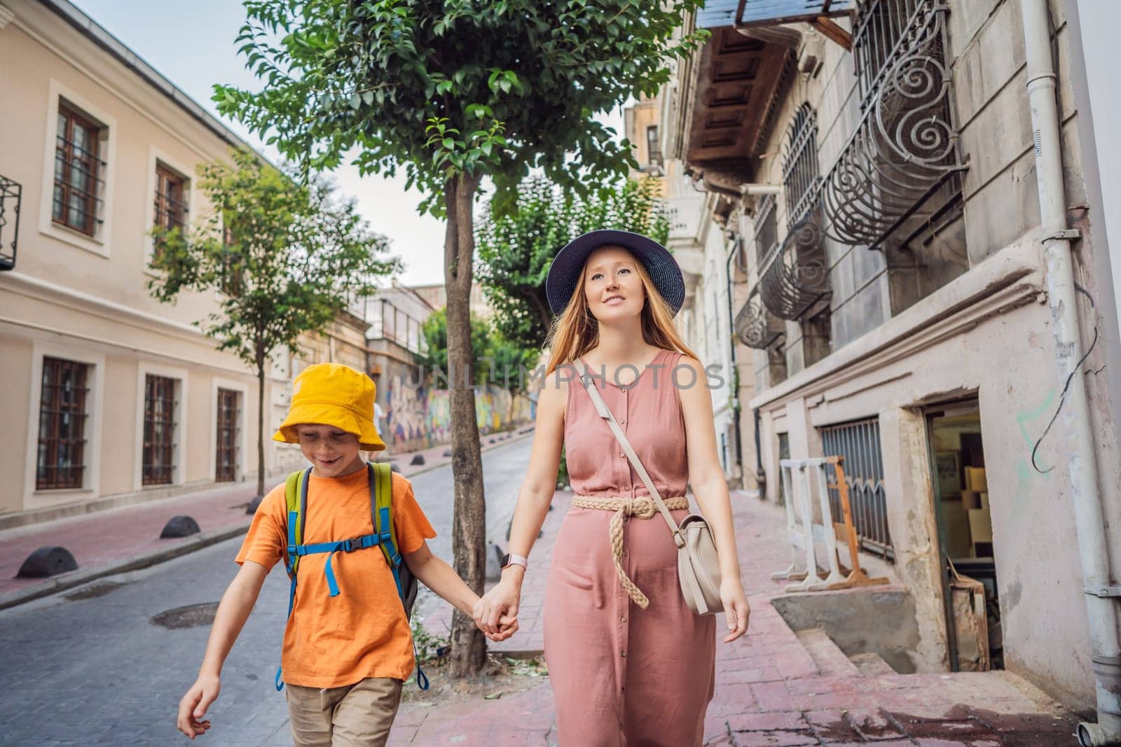 Mother and son tourists walk through the old streets of Istanbul. Travel to istanbul concept. Traveling with kids concept by galitskaya