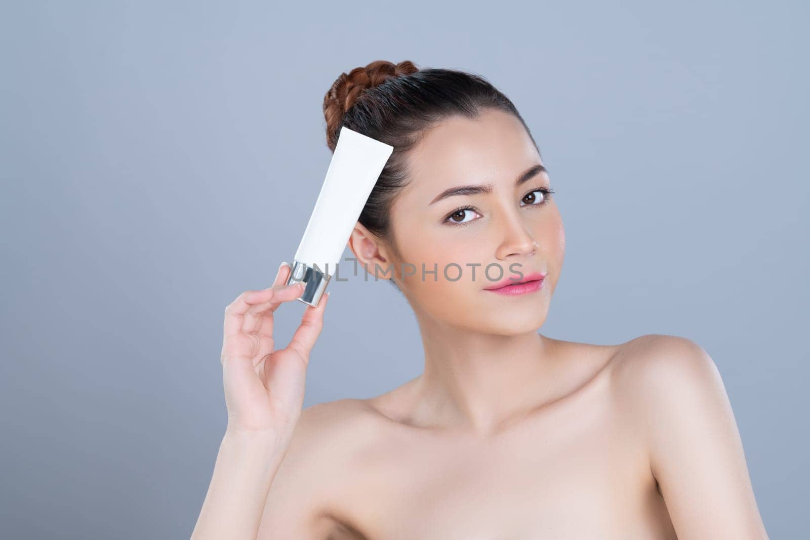 Glamorous perfect skin woman holding mockup moisturizer tube. by biancoblue