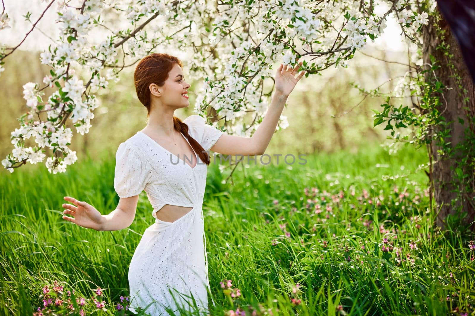 Pretty woman in blossom spring garden. High quality photo