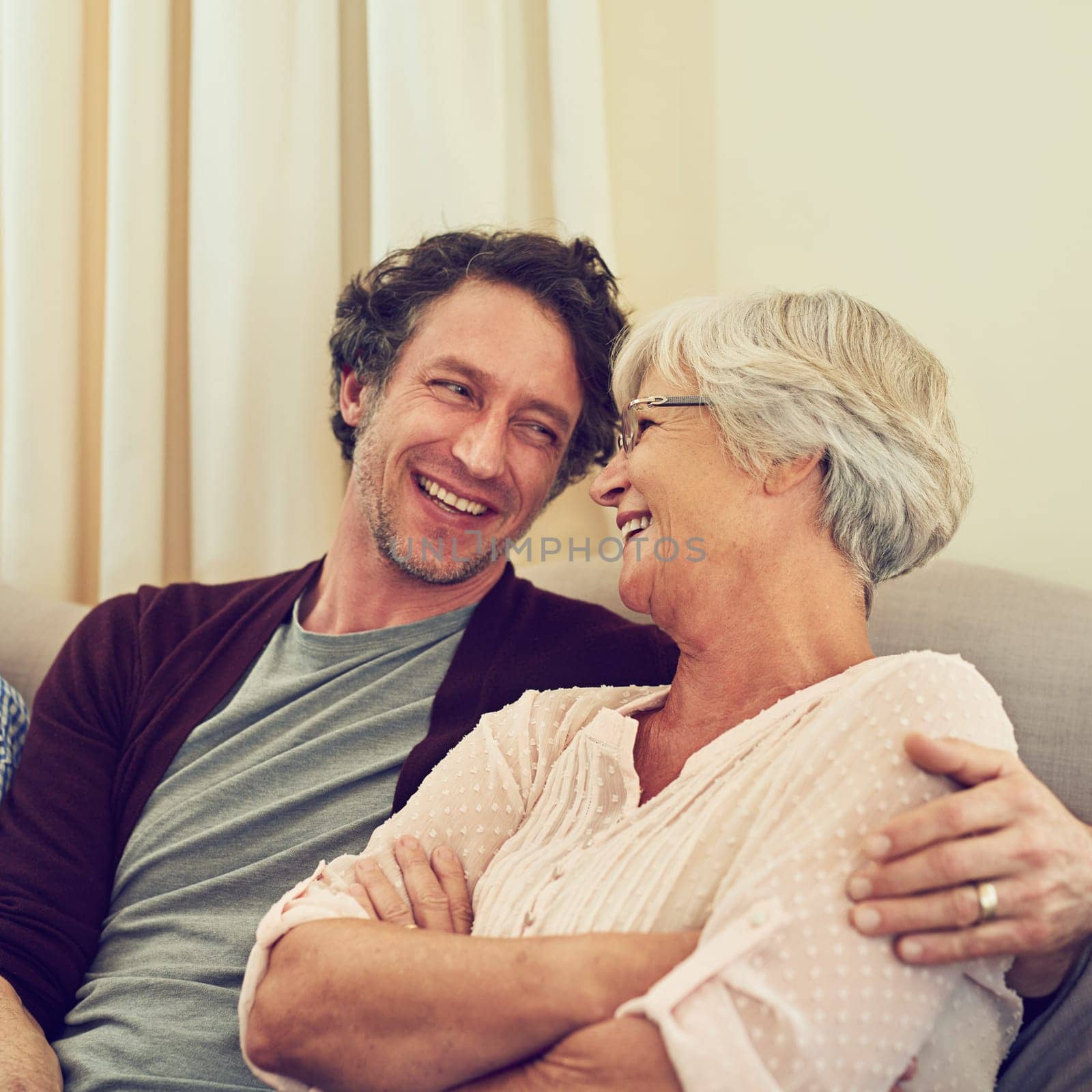 You may be married, but youre still my boy. a man and his elderly mother sitting together at home