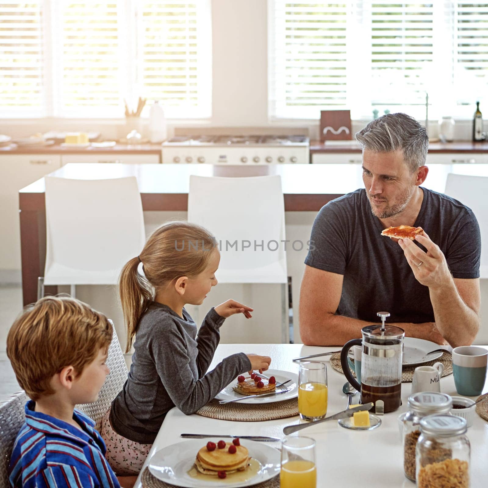 Hes a hands-on dad. a family having breakfast together