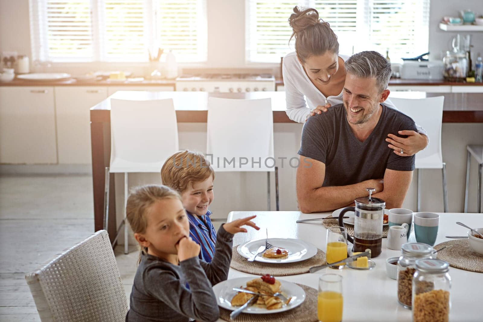 Building strong family ties. a family having breakfast together. by YuriArcurs