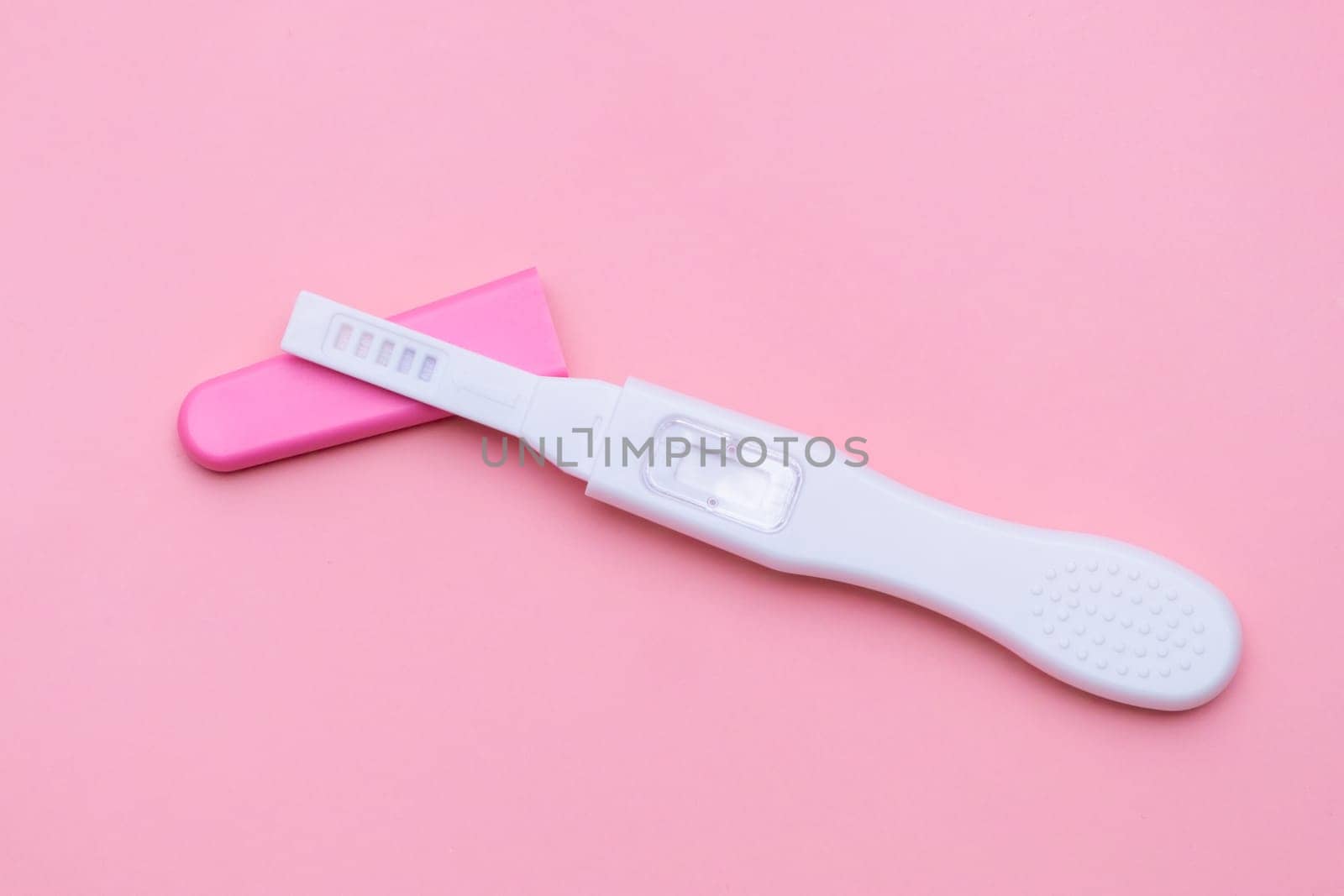 Unused pregnancy test isolated on the pink background.