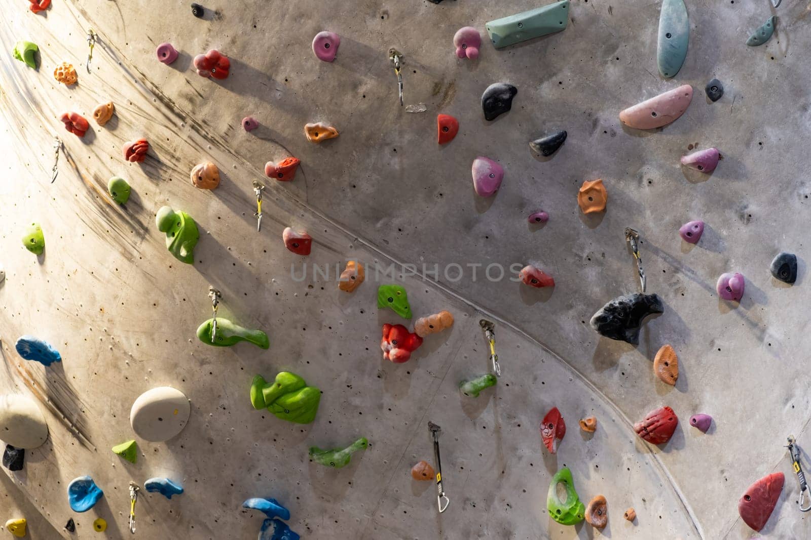 Artificial rock climbing wall with various colored grips.