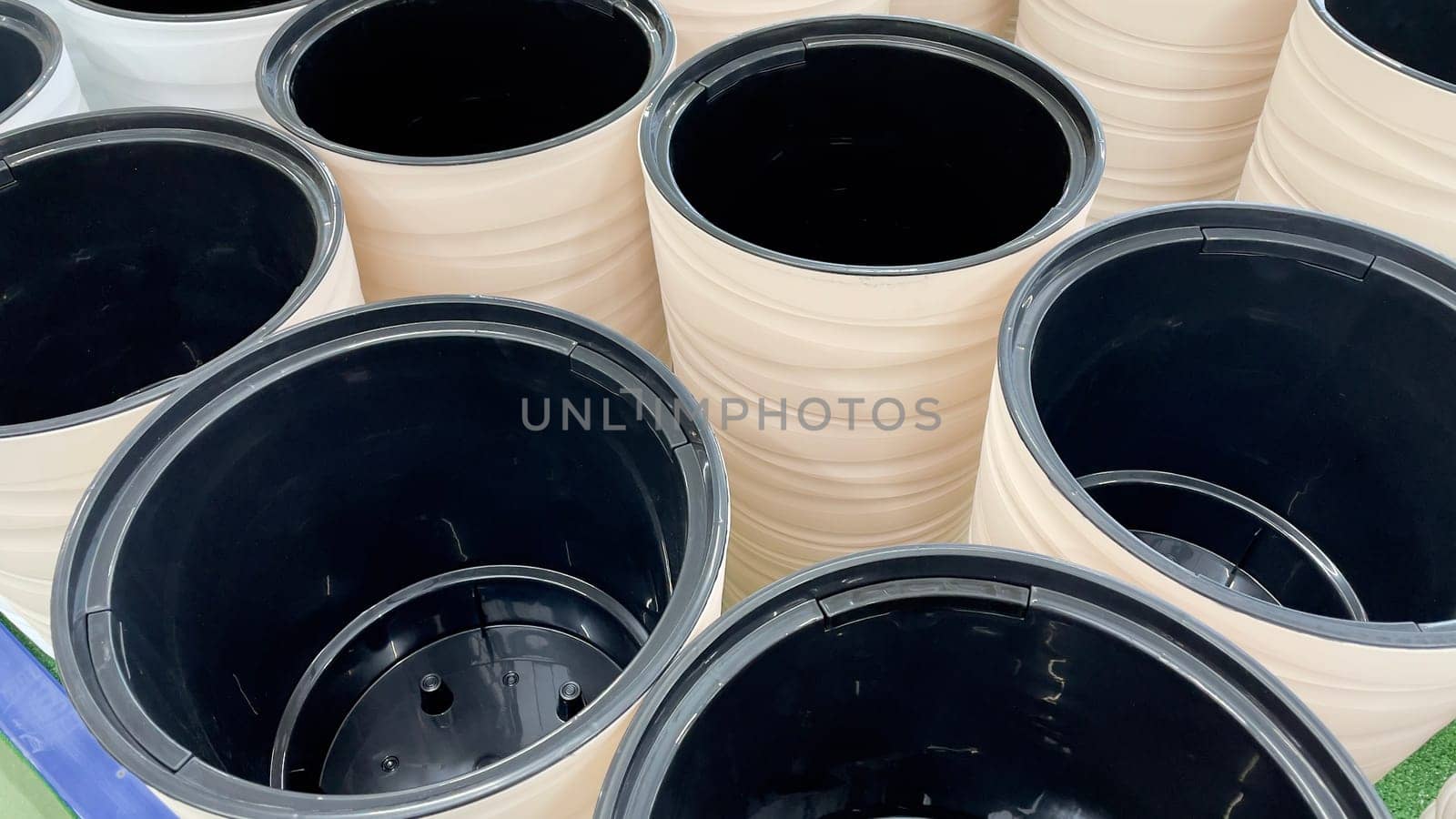Close-up of empty flower pots in a store or greenhouse. Colorful pots for plants. Gardening and landscape design concept.